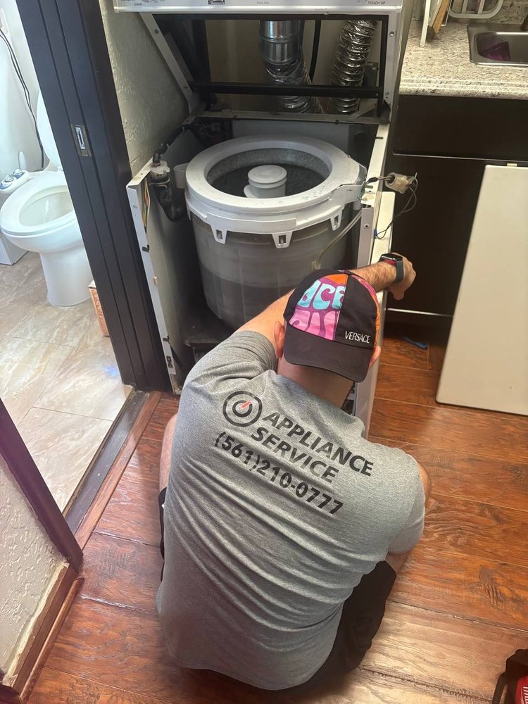 IO Appliance technician repairing washer drum