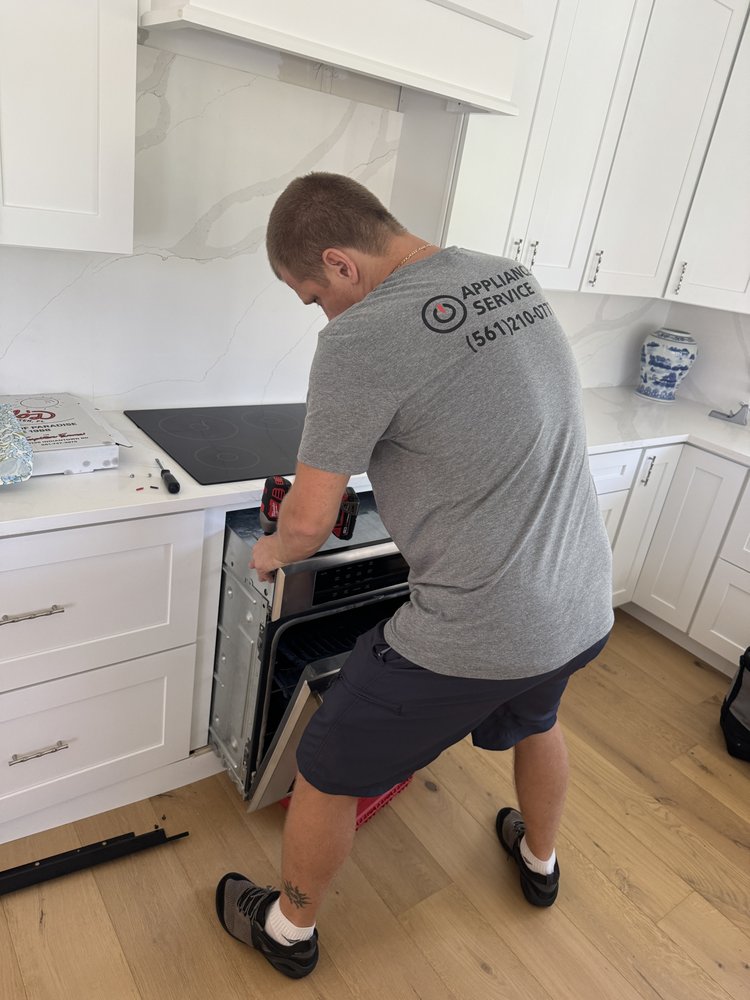 IO Appliance technician servicing oven
